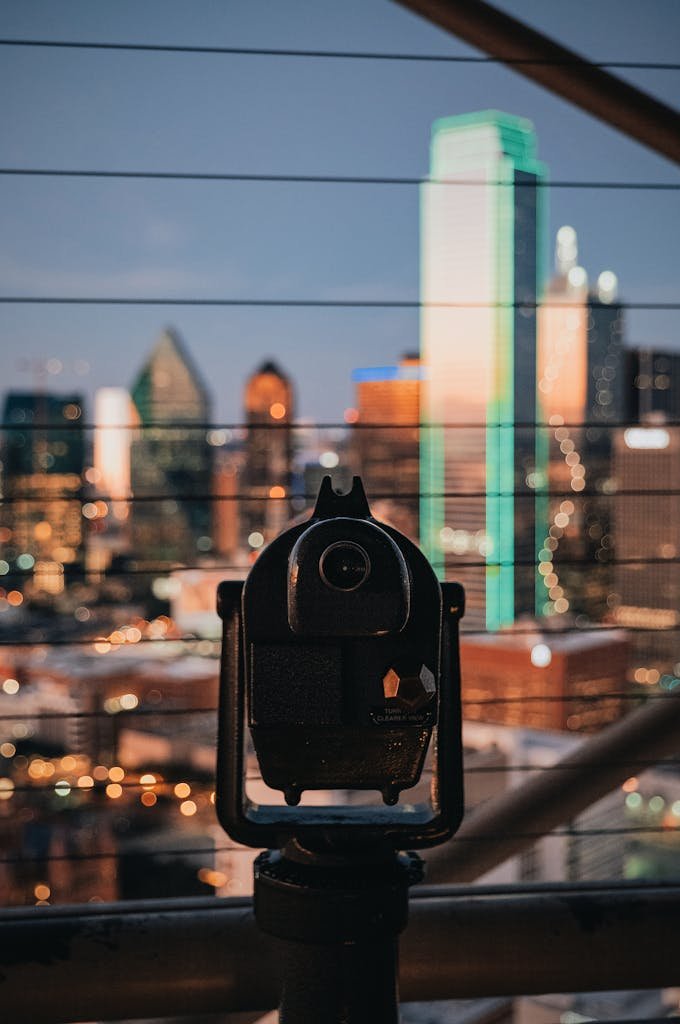 A viewfinder overlooks the Dallas skyline at twilight, capturing the city's modern architecture.