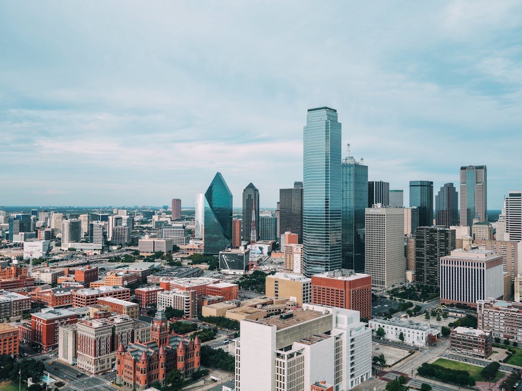 Aerial view of the vibrant Dallas skyline with iconic skyscrapers and urban landscape.